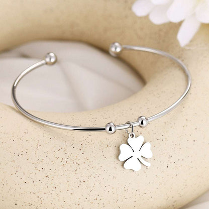 Leaf Clover Open Bracelet in gold and silver with a flexible open design.