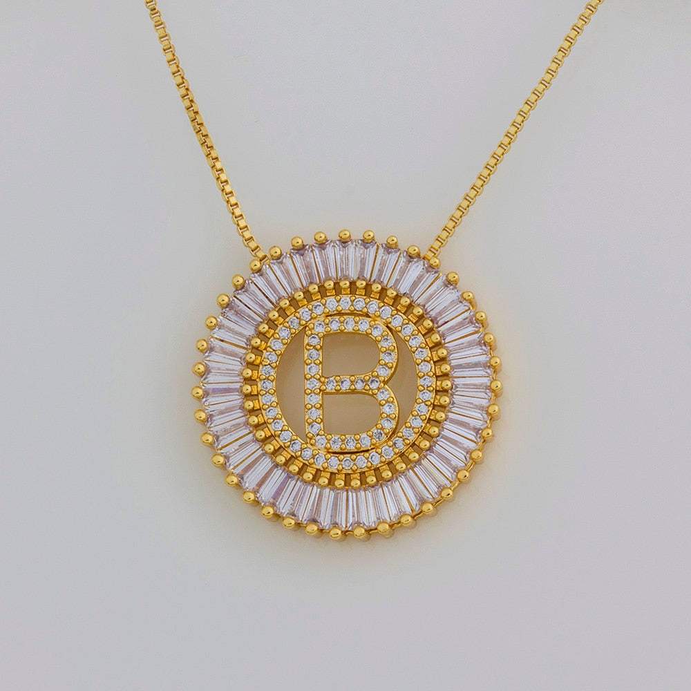 YourLetter Gem Circle Pendant Necklace with custom letter and imitation gems in gold.