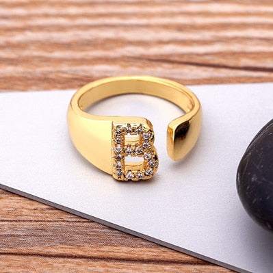 Wide YourLetter Initial Ring with cubic zirconia gems on adjustable gold band.