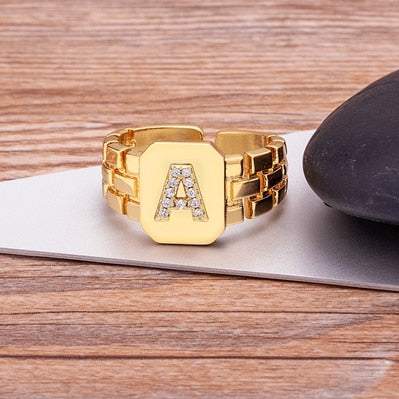 Yourletter Chunky Embossed Ring with imitation gems and custom letter A in gold color.