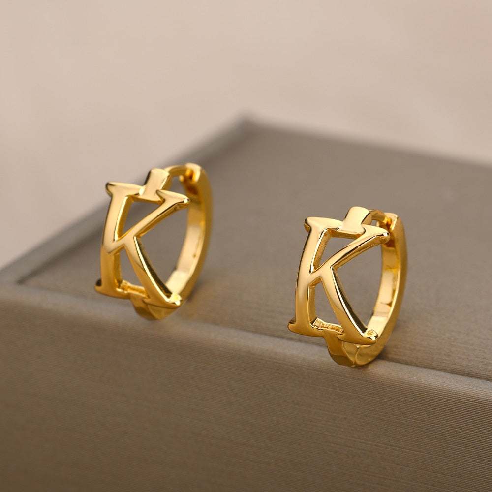 Gold initial loop earring with customizable letter design.