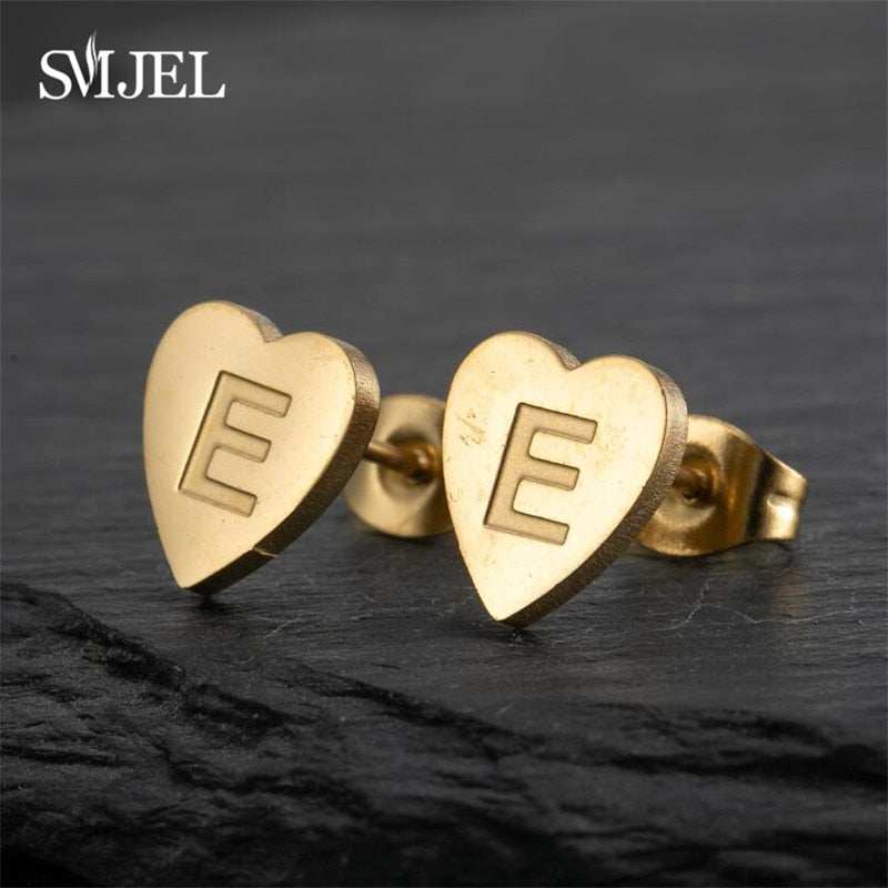 Heart-shaped stud earrings with personalized initial in gold finish, versatile design by YourLetter.