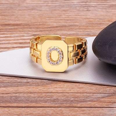 Yourletter Chunky Embossed Ring with imitation gems in gold color featuring adjustable design.