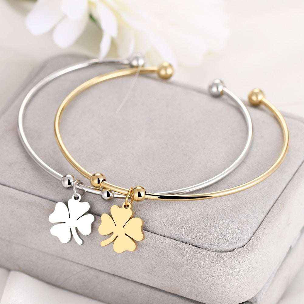 Gold and silver Four Leaf Clover Open Bracelet on display.