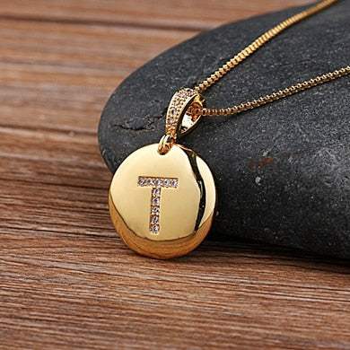 Customizable jeweled pendant chain with gold letter T.