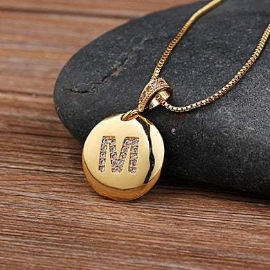 YourLetter Jeweled Pendant Chain with gold color and gem-encrusted letter pendant.