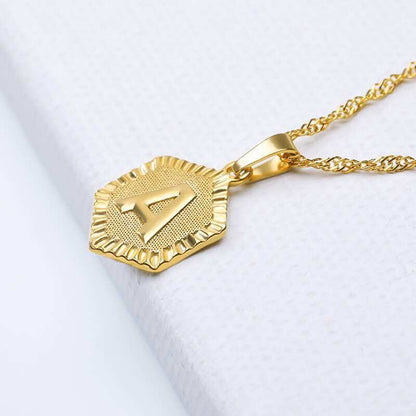 YourLetter Hexagon Embossed Necklace in gold with personalized letter.