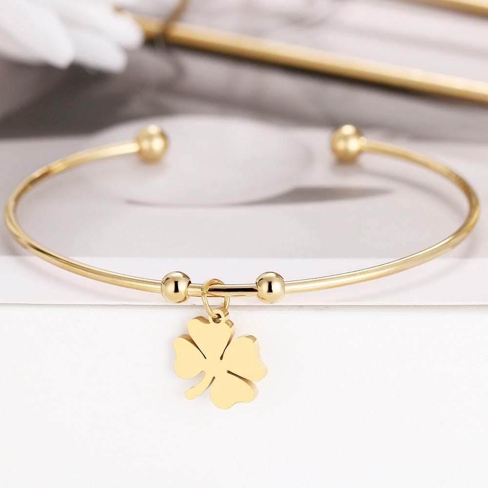 Leaf Clover Open Bracelet in gold and silver with adjustable design.