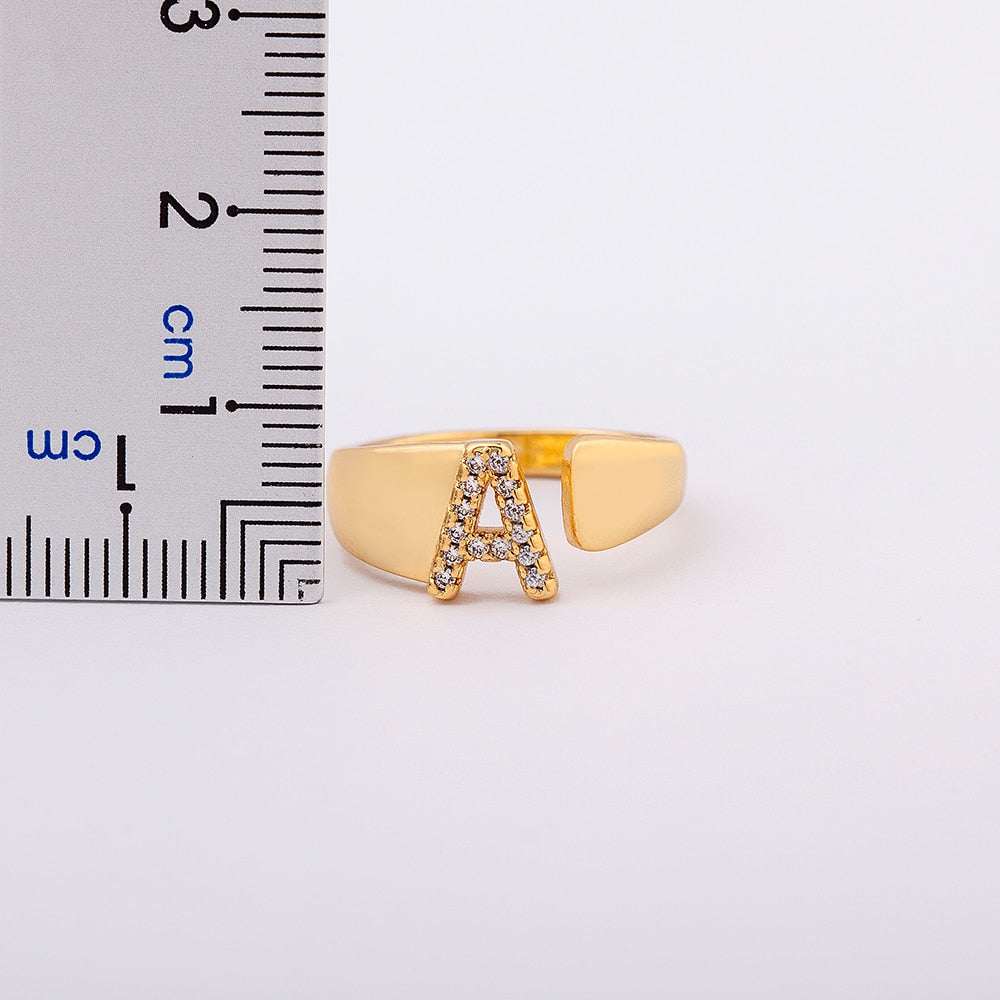 Wide YourLetter Initial Ring with cubic zirconia gems and adjustable band.