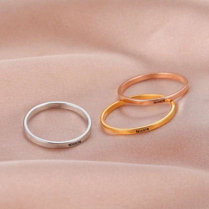 Custom engraved rings in gold, rose gold, and silver on display.