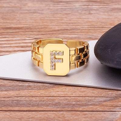 Yourletter Chunky Embossed Ring with imitation gems and adjustable gold band featuring an embossed letter.