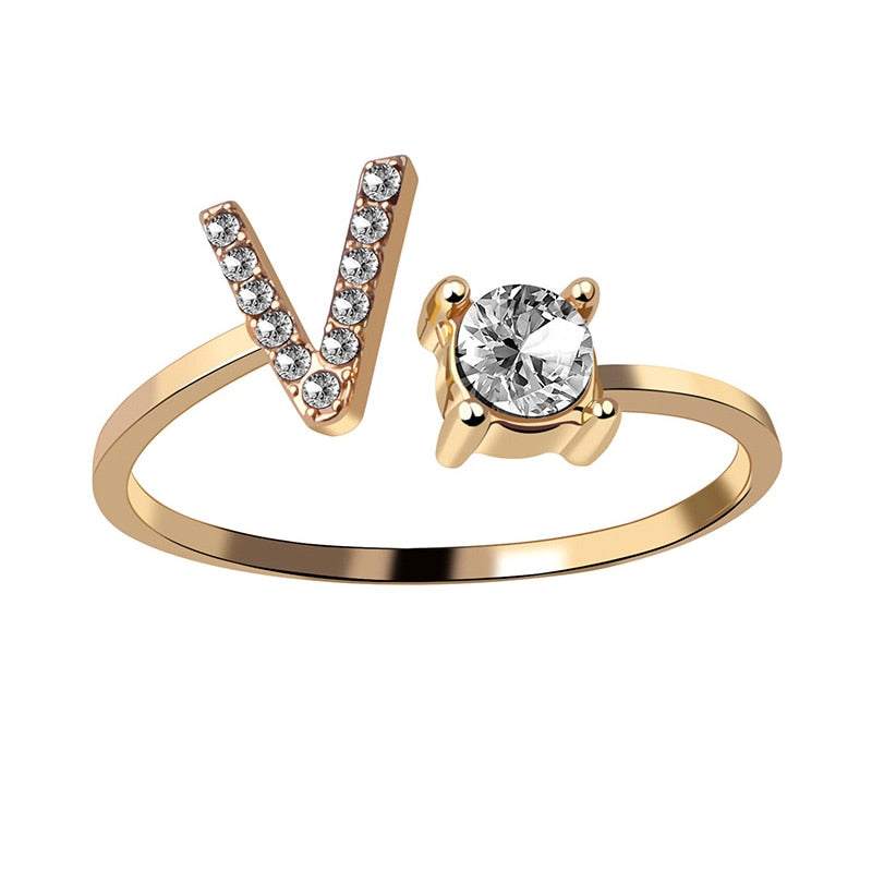 Gold adjustable letter ring with gem stud.