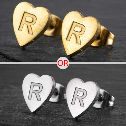 Heart-shaped stud earrings with personalized initial in silver and gold finish.