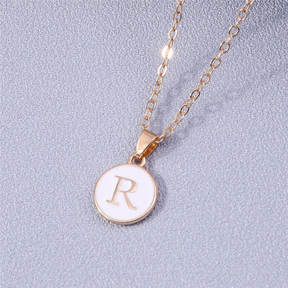 YourLetter White Enamel Circle Necklace with gold detailing and personalized letter pendant.