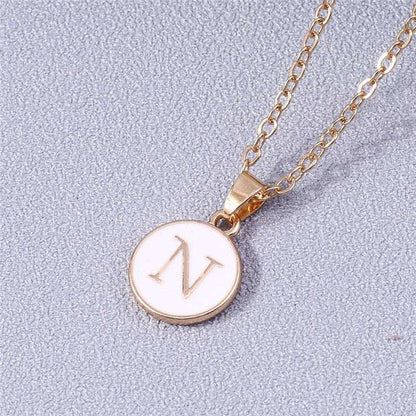 YourLetter White Enamel Circle Necklace with gold detailing and initial pendant.