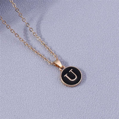 YourLetter Black Enamel Necklace with personalized letter pendant in gold color and black background.