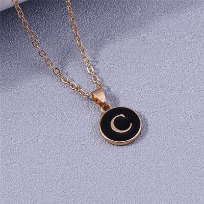 YourLetter Black Enamel Necklace with gold chain and letter pendant.