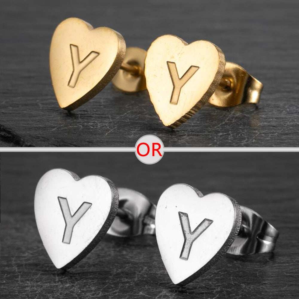 Personalized initial heart stud earrings in silver and gold finish.