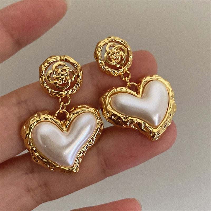 Warped Heart Earrings in silver and gold with exquisite design.