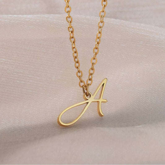 Gold YourLetter initial necklace with handwritten design.