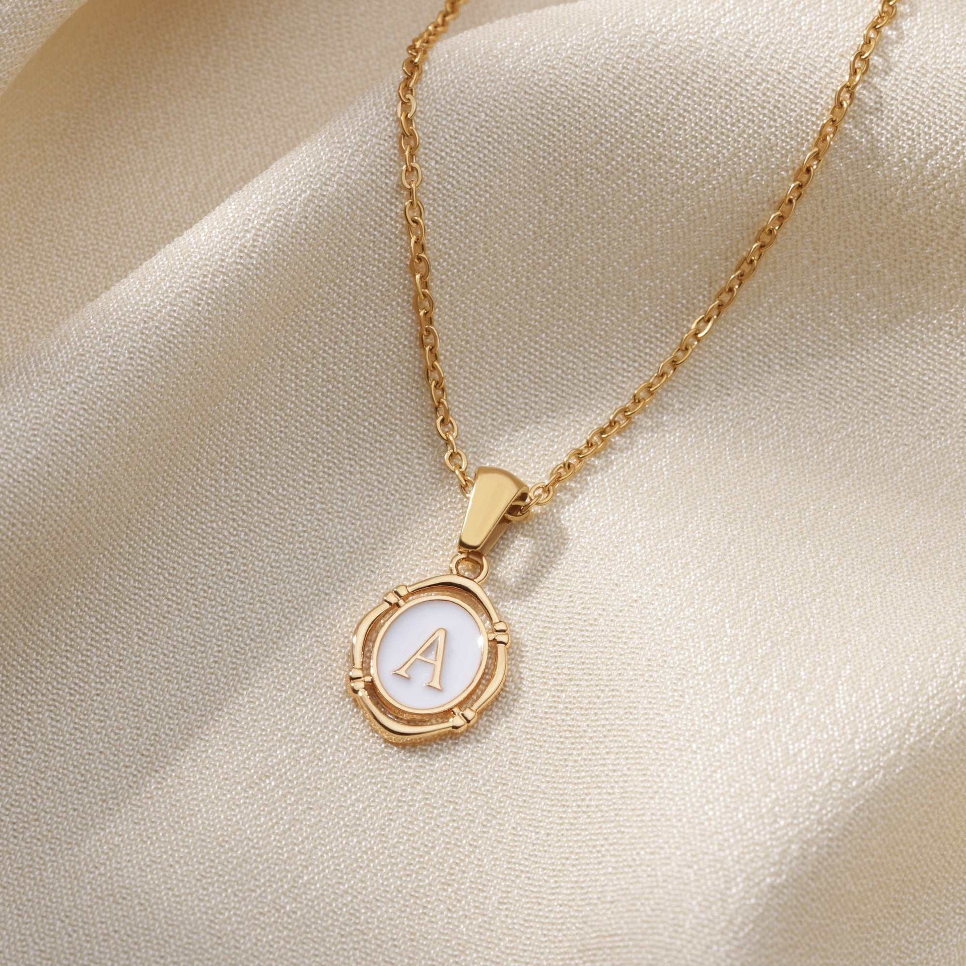 Gold framed YourLetter enamel necklace with personalized letter pendant on a 45cm chain.