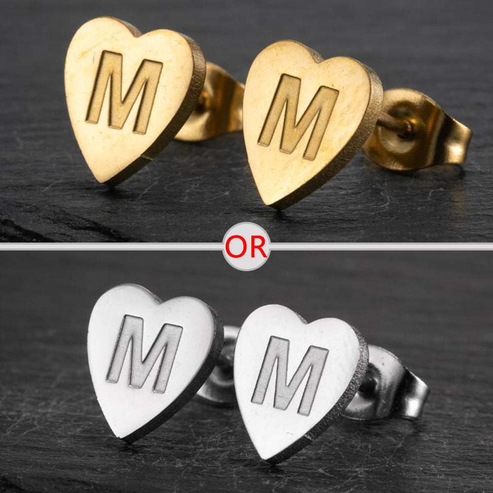 Heart-shaped stud earrings with a personalized initial in gold and silver finishes.