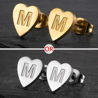 Heart-shaped stud earrings with a personalized initial in gold and silver finishes.