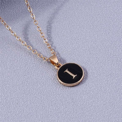 YourLetter black enamel necklace with gold chain and letter pendant.