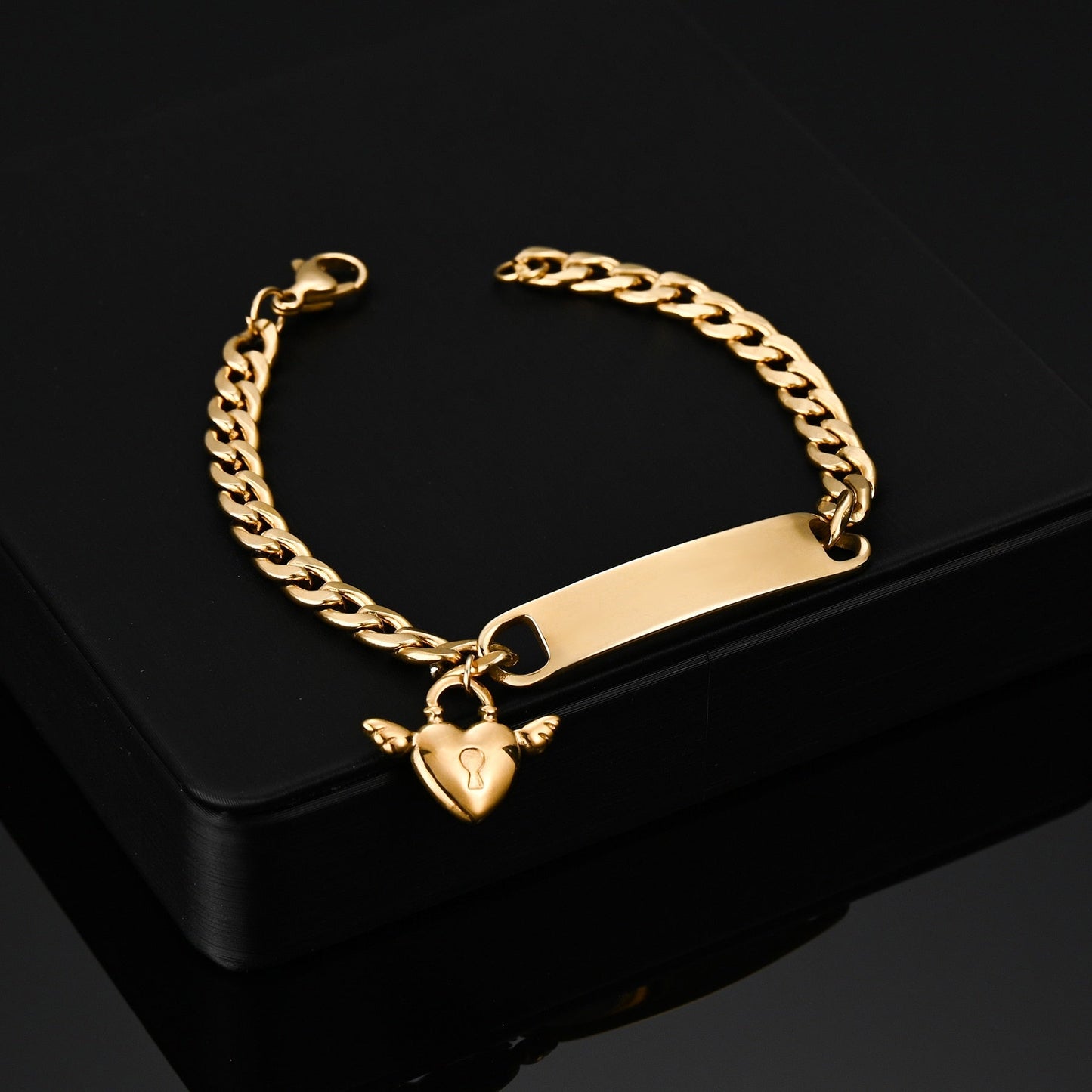 Engraved nameplate bracelet with Cuban chain and pendant, gold color.