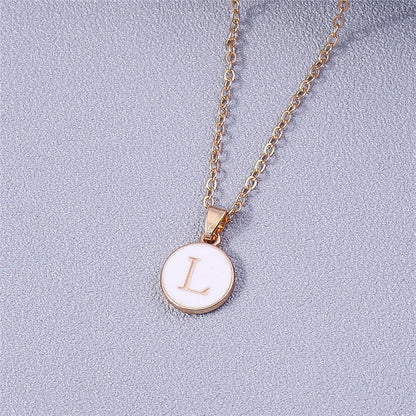 YourLetter White Enamel Circle Necklace with personalized letter pendant and gold detailing.