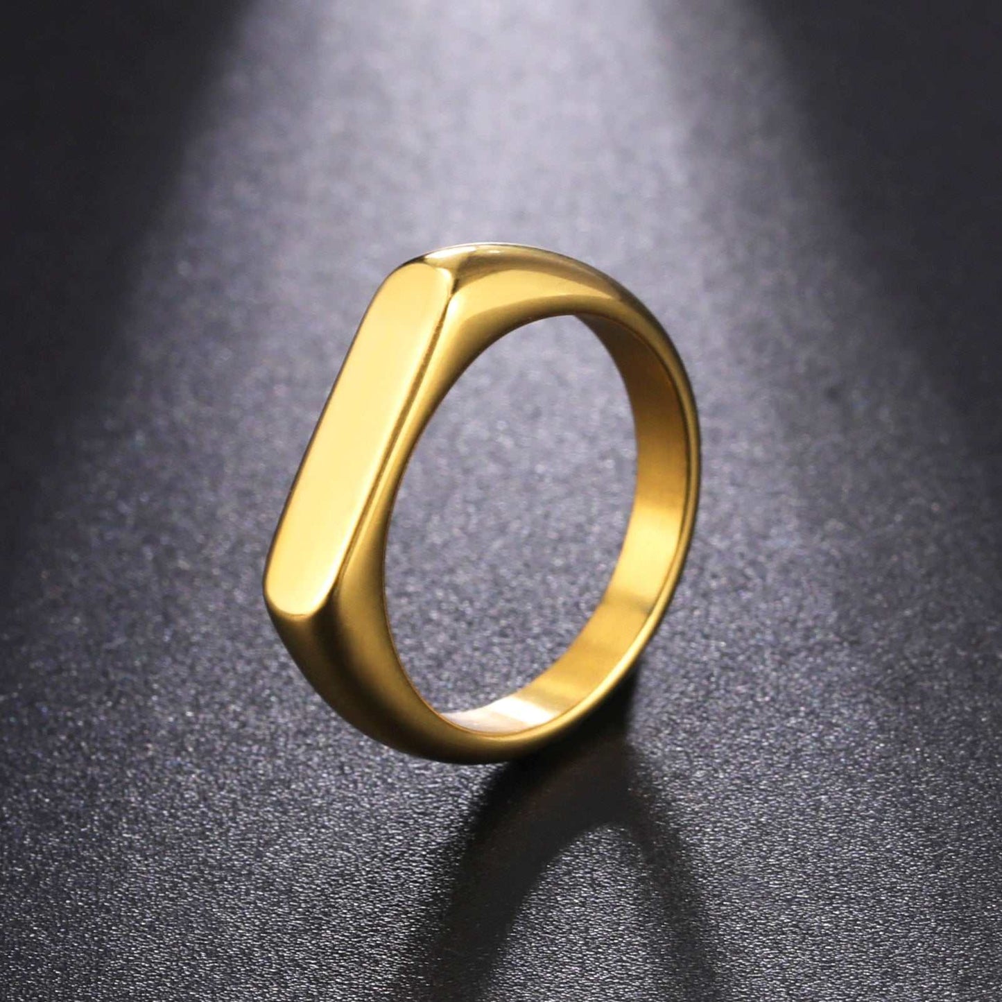 Engraved custom name flat band ring in gold finish.