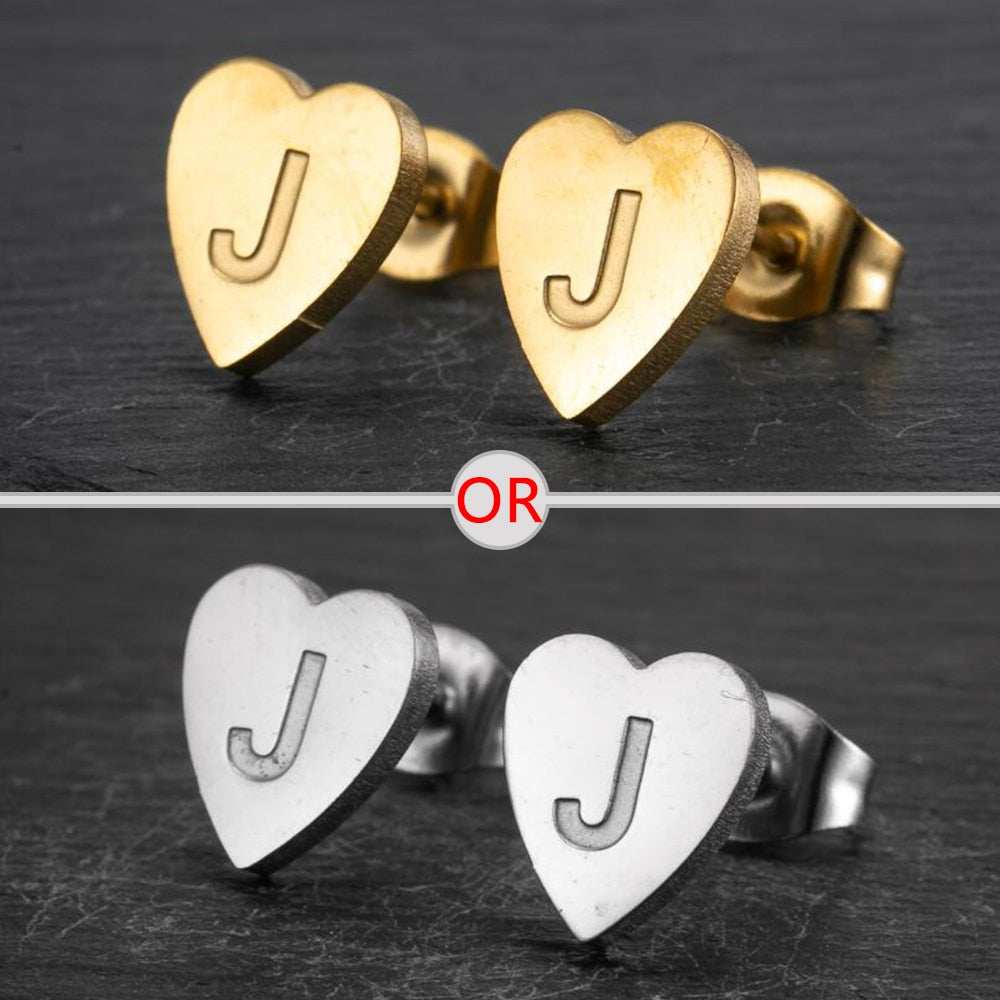 Heart-shaped stud earrings with personalized initial, available in silver or gold finish.