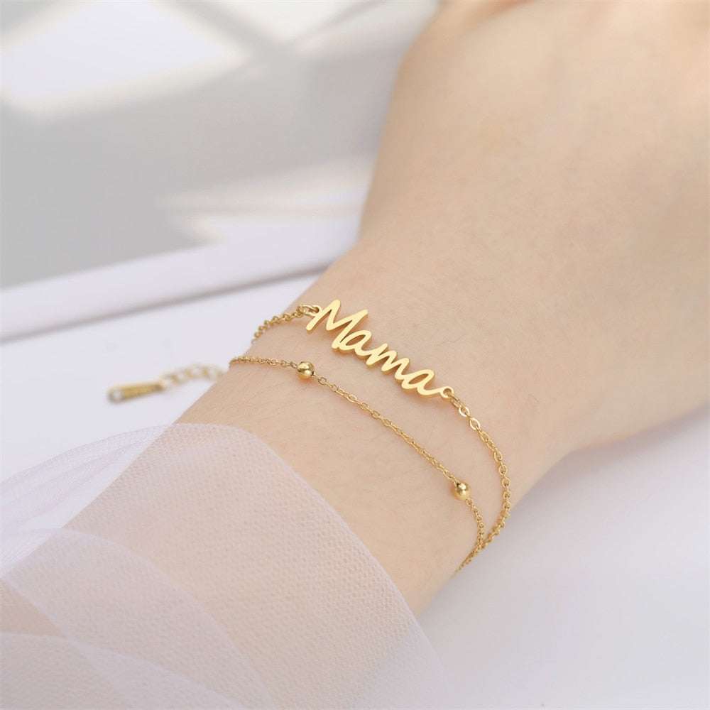 Mama bracelet with multiple style choices in gold, silver, red, or black.