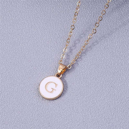 YourLetter White Enamel Circle Necklace with customizable letter pendant in gold detailing.