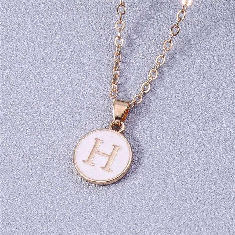 YourLetter White Enamel Circle Necklace with gold detailing and customizable letter pendant.