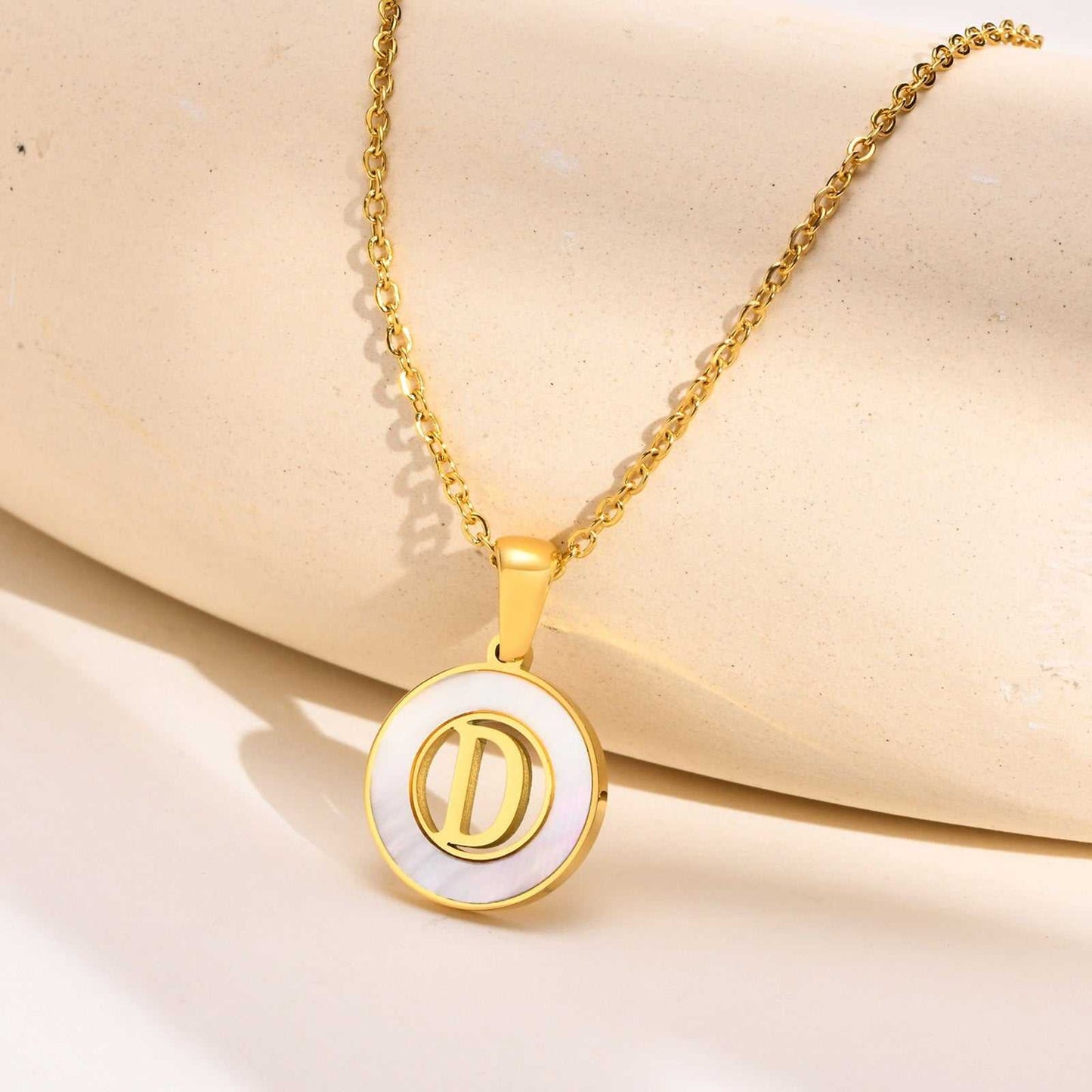 Hollow Shell Circle YourLetter Pendant Necklace in gold-colored metal with customizable letter.