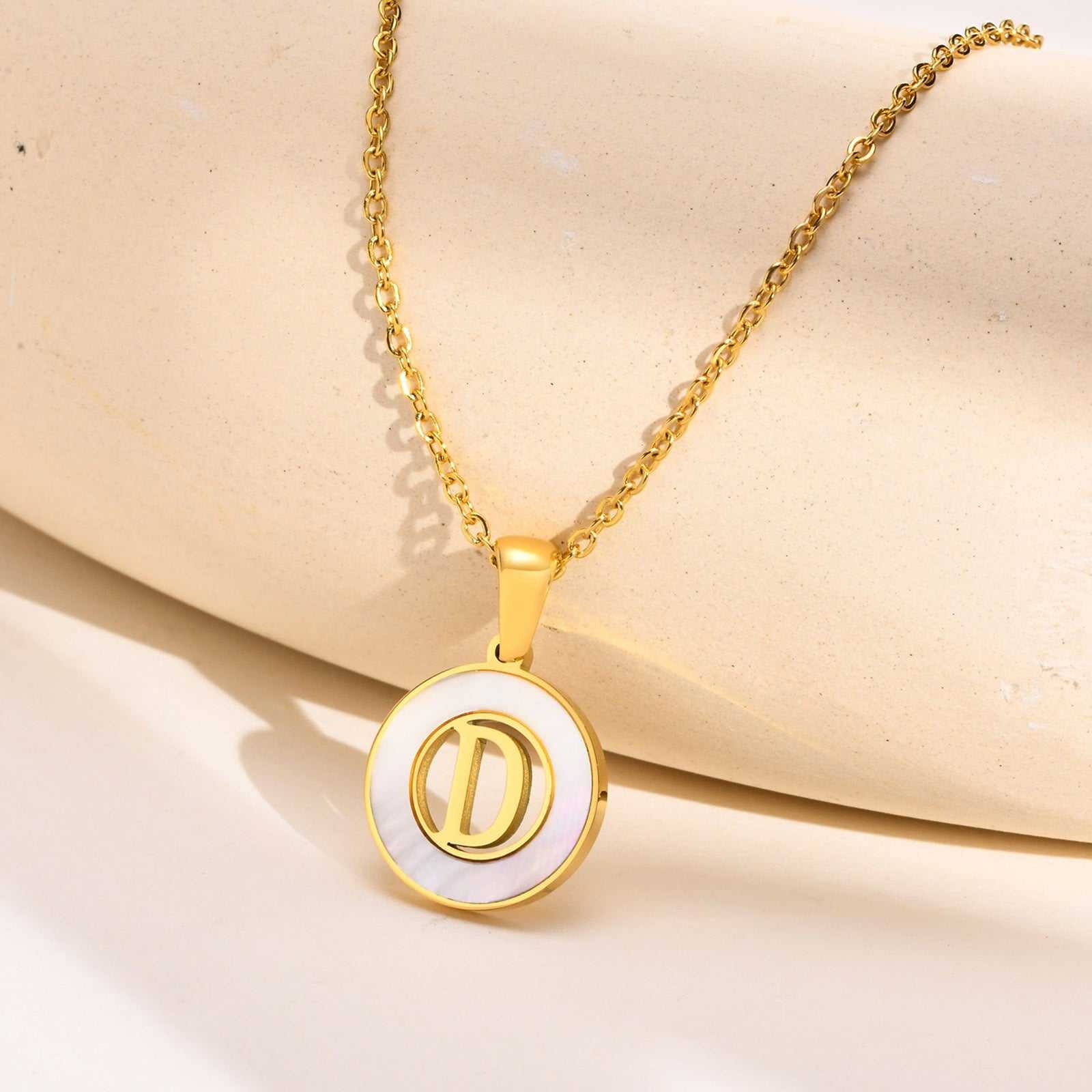 Hollow Shell Circle YourLetter Pendant Necklace in gold-colored metal with customizable letter.