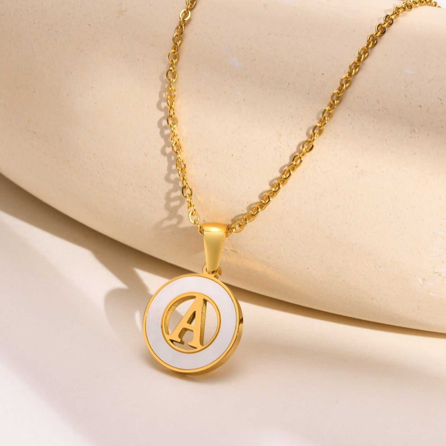 Hollow Shell Circle YourLetter Pendant Necklace with gold alloy and customizable letter design.