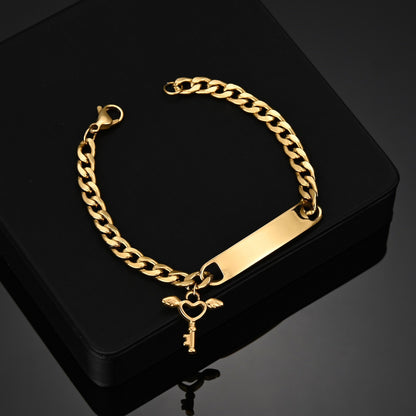 Engraved Nameplate Bracelet Cuban Chain with Key Pendant on black background.