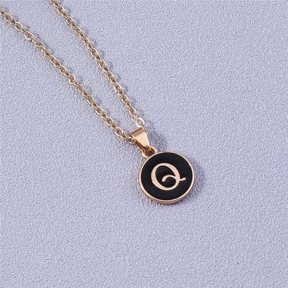 YourLetter Black Enamel Necklace with gold chain and letter pendant.