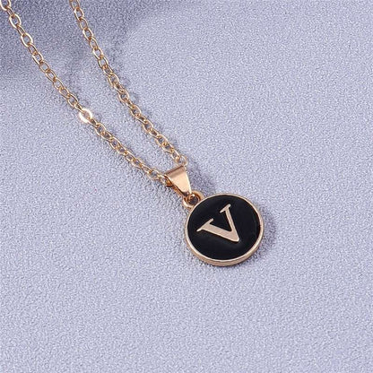 YourLetter Black Enamel Necklace with gold chain and letter pendant.