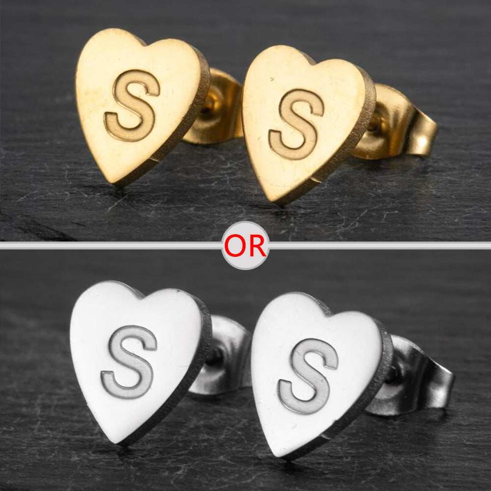 Heart stud earrings with personalized initial in gold and silver finish.