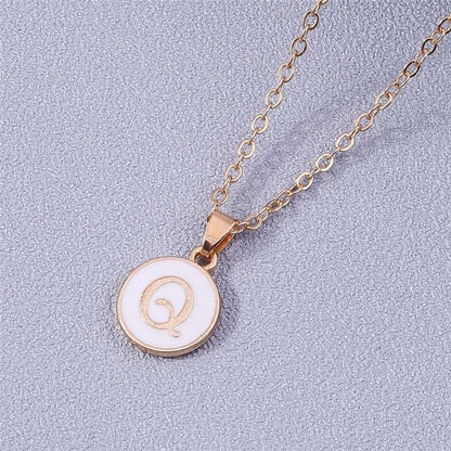 YourLetter White Enamel Circle Necklace with gold detailing and initial pendant.