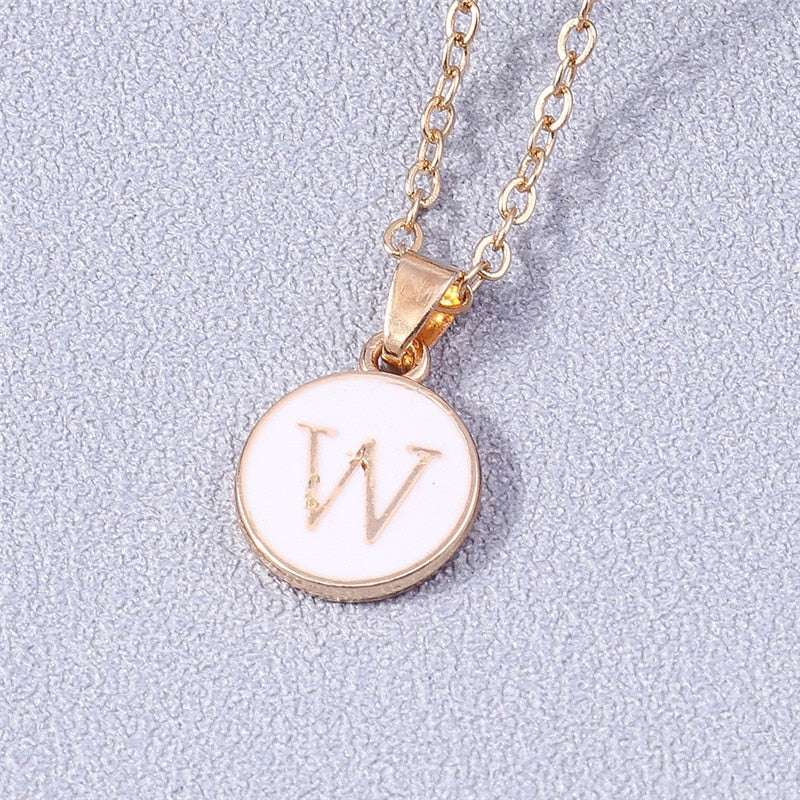 Customizable YourLetter White Enamel Circle Necklace with gold detailing and letter pendant.