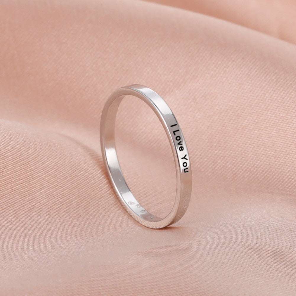 Custom engraved ring in silver with personalized text.