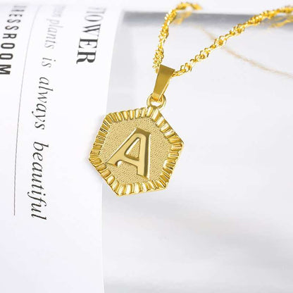 YourLetter Hexagon Embossed Necklace with gold finish and personalized letter.