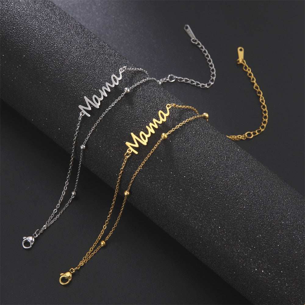 Mama bracelet with multiple style choices in gold or silver with chain, and red or black string options.