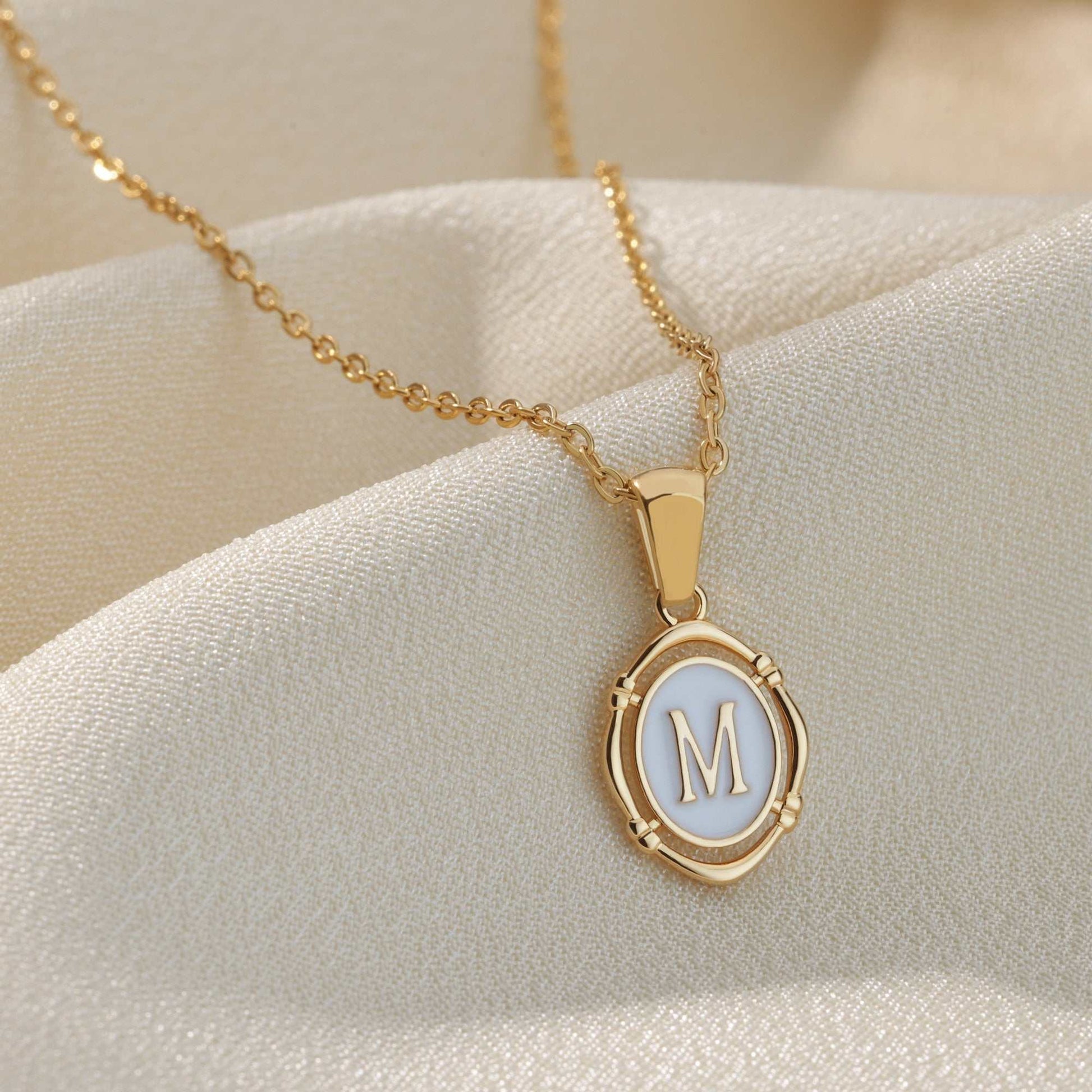 Framed YourLetter Enamel Necklace with gold finish and personalized letter pendant.