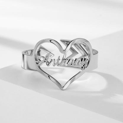 Customizable heart arrow ring in silver with personalized name engraving.